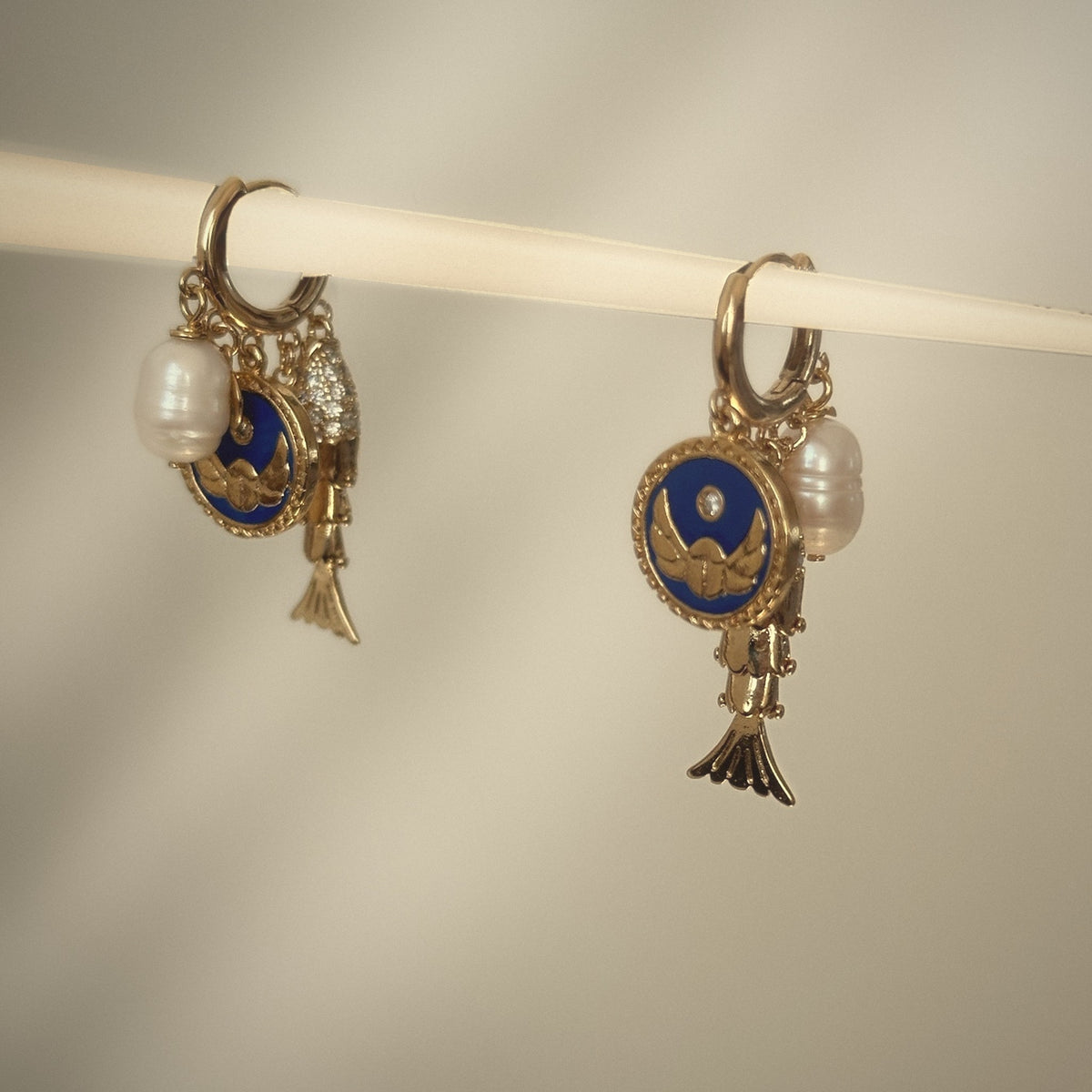 Saltwater Spell Asymmetrical Earrings, huggie hoops with evil eye, fish and pearl